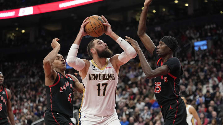 Feb 23, 2023; Toronto, Ontario, CAN; Toronto Raptors forward Chris Boucher (25) and forward Scottie Barnes (4) defnd against New Orleans Pelicans center Jonas Valanciunas (17) during the second half at Scotiabank Arena. Mandatory Credit: John E. Sokolowski-USA TODAY Sports
