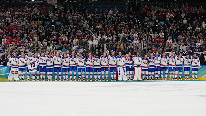 Team USA men’s hockey team listen to the national anthem be played after winning the Olympic gold medal.