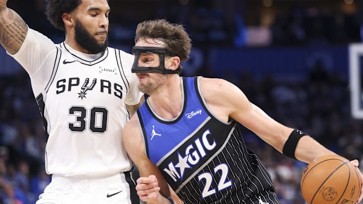 Dec 3, 2025; Orlando, Florida, USA; Orlando Magic forward Franz Wagner (22) moves the ball past San Antonio Spurs forward Julian Champagnie (30) in the third quarter at Kia Center. Mandatory Credit: Nathan Ray Seebeck-Imagn Images