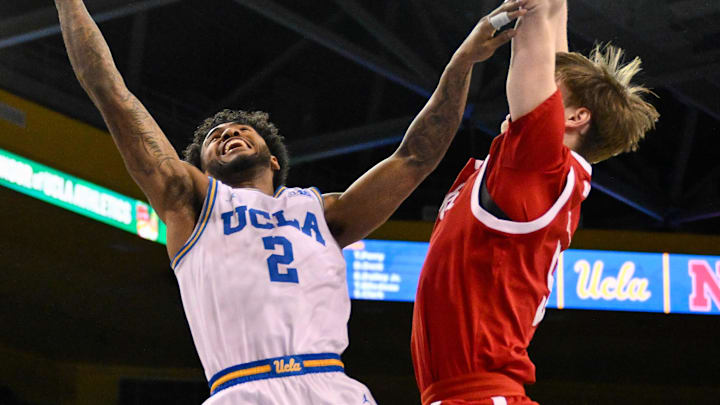 Mar 3, 2026; Los Angeles, California, USA; UCLA Bruins guard Donovan Dent (2) drives to the basket as NNebraska Cornhuskers forward Braden Frager (5) tries to defend during the 1st half at Pauley Pavilion presented by Wescom Financial. Mandatory Credit: Robert Hanashiro-Imagn Images