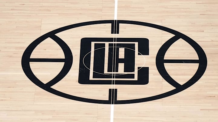 May 1, 2024; Los Angeles, California, USA; A general overall view as Dallas Mavericks guard Luka Doncic (77) is defended by LA Clippers guard Terance Mann (14) near the Clippers logo at midcourt in the first half during game five of the first round for the 2024 NBA playoffs at Crypto.com Arena. Mandatory Credit: Kirby Lee-Imagn Images