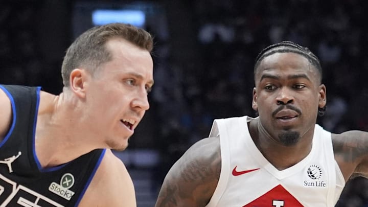 Detroit Pistons guard Duncan Robinson drives to the net against Toronto Raptors guard Jamal Shead.