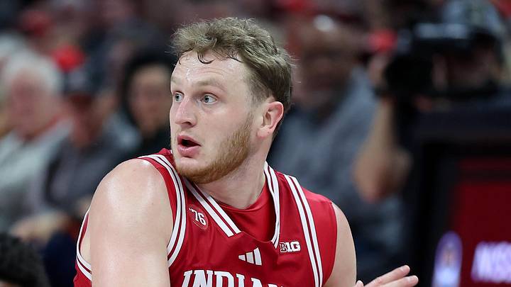Mar 7, 2026; Columbus, Ohio, USA; Indiana Hoosiers forward Tucker Devries (12) goes to the floor for a loose ball as Ohio State Buckeyes forward Amare Bynum (1) defends during the first half at Value City Arena. Mandatory Credit: Joseph Maiorana-Imagn Images