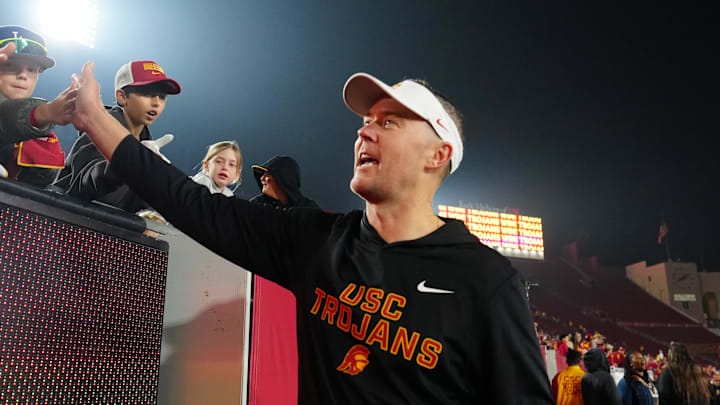 Nov 29, 2025; Los Angeles, California, USA; Southern California Trojans head coach Lincoln Riley celebrates with fans after the game against the UCLA Bruins at United Airlines Field at Los Angeles Memorial Coliseum. Mandatory Credit: Kirby Lee-Imagn Images Nov 29, 2025; Los Angeles, California, USA; Southern California Trojans head coach Lincoln Riley celebrates with fans after the game against the UCLA Bruins at United Airlines Field at Los Angeles Memorial Coliseum. Mandatory Credit: Kirby Lee-Imagn Images