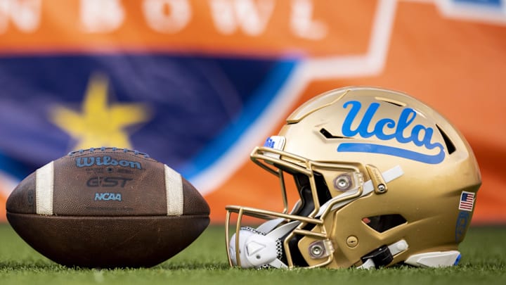 Dec 30, 2022; El Paso, Texas, USA; Helmets of the Pittsburgh Panthers and UCLA Bruins are posed in front of the logo before the 2022 Sun Bowl at Sun Bowl. Mandatory Credit: Ivan Pierre Aguirre-Imagn Images