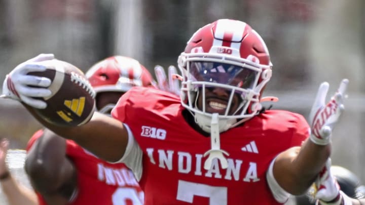 Sep 6, 2025; Bloomington, Indiana, USA; Indiana Hoosiers defensive lineman Kellan Wyatt (13) and defensive back Louis Moore (7) celebrate after forcing a turnover during the second half against the Kennesaw State Owls at Memorial Stadium. 