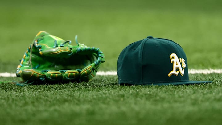 Jul 22, 2025; Arlington, Texas, USA; Athletics glove and hat on the field before the game against the Texas Rangers at Globe Life Field. Mandatory Credit: Kevin Jairaj-Imagn Images Jul 22, 2025; Arlington, Texas, USA; Athletics glove and hat on the field before the game against the Texas Rangers at Globe Life Field. Mandatory Credit: Kevin Jairaj-Imagn Images
