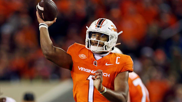 Oct 17, 2024; Blacksburg, Virginia, USA; Virginia Tech Hokies quarterback Kyron Drones (1) throws a touchdown during the second quarter against the Boston College Eagles at Lane Stadium. Mandatory Credit: Peter Casey-Imagn Images