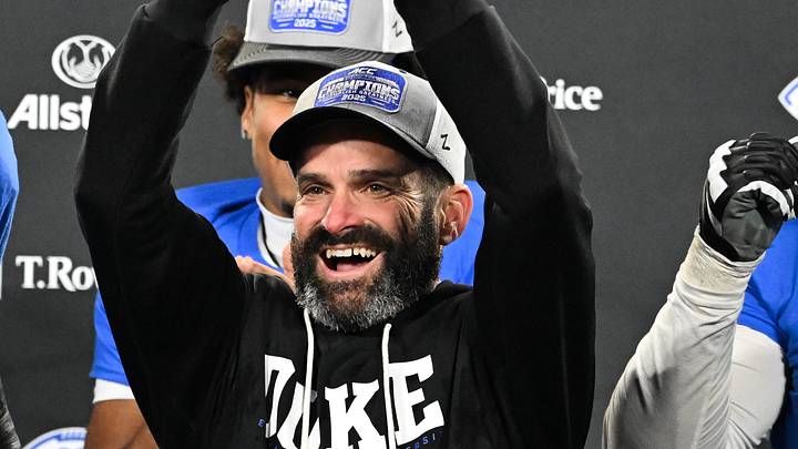 Dec 6, 2025; Charlotte, NC, USA; Duke Blue Devils head coach Manny Diaz lifts the ACC trophy with offensive lineman Justin Pickett (77) and defensive tackle Aaron Hall (99) after defeating the Virginia Cavaliers at the 2025 ACC Championship game at Bank of America Stadium. Mandatory Credit: Bob Donnan-Imagn Images Dec 6, 2025; Charlotte, NC, USA; Duke Blue Devils head coach Manny Diaz lifts the ACC trophy with offensive lineman Justin Pickett (77) and defensive tackle Aaron Hall (99) after defeating the Virginia Cavaliers at the 2025 ACC Championship game at Bank of America Stadium. Mandatory Credit: Bob Donnan-Imagn Images