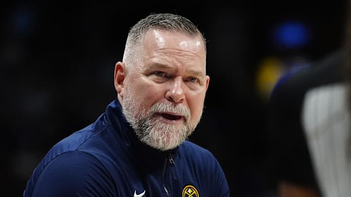 Apr 6, 2025; Denver, Colorado, USA; Denver Nuggets head coach Michael Malone reacts towards referee Danielle Scott (87) in the second half against the Indiana Pacers at Ball Arena. Mandatory Credit: Ron Chenoy-Imagn Images