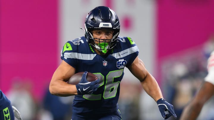 Jan 17, 2026; Seattle, WA, USA; Seattle Seahawks running back Zach Charbonnet (26) carries the ball against the San Francisco 49ers during the first half in an NFC Divisional Round game at Lumen Field. Mandatory Credit: Steven Bisig-Imagn Images