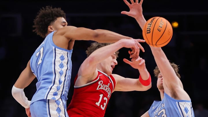 Dec 20, 2025; Atlanta, Georgia, USA; North Carolina Tar Heels guard Seth Trimble (7) and center Henri Veesaar (13) defend Ohio State Buckeyes center Christoph Tilly (13) in the second half at State Farm Arena. Mandatory Credit: Brett Davis-Imagn Images
