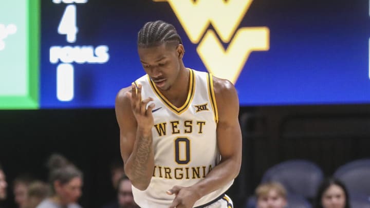 Mar 6, 2026; Morgantown, West Virginia, USA; West Virginia Mountaineers forward Brenen Lorient (0) celebrates after a made basket during the first half against the UCF Knights at Hope Coliseum. Mandatory Credit: Ben Queen-Imagn Images