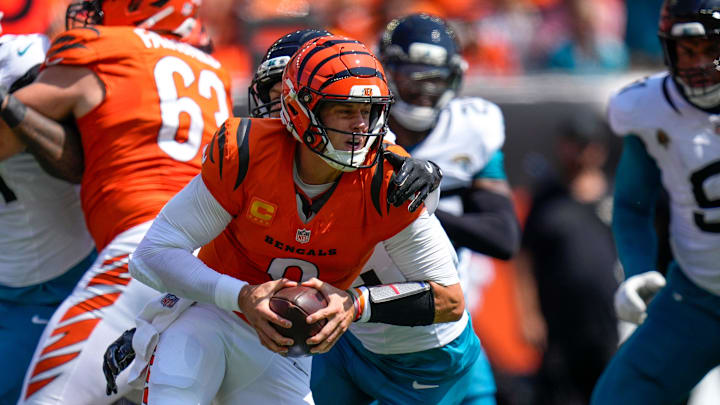 Cincinnati Bengals quarterback Joe Burrow (9) is wrapped up as he scrambles in the first quarter of the NFL Week 2 game between the Cincinnati Bengals and the Jacksonville Jaguars at Paycor Stadium in downtown Cincinnati on Sunday, Sept. 14, 2025. The Jaguars led 17-10 at halftime.