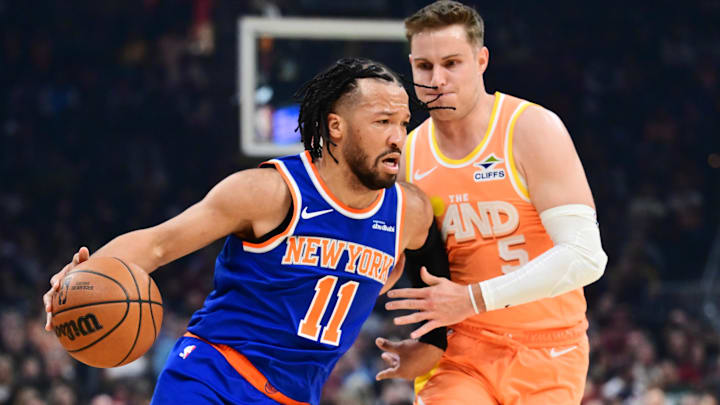 Feb 24, 2026; Cleveland, Ohio, USA; New York Knicks guard Jalen Brunson (11) drives to the basket against Cleveland Cavaliers guard Sam Merrill (5) during the first half at Rocket Arena. Mandatory Credit: Ken Blaze-Imagn Images