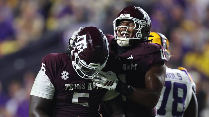 Oct 25, 2025; Baton Rouge, Louisiana, USA; Texas A&M Aggies defensive tackle DJ Hicks (5) celebrates with defensive tackle Tyler Onyedim (11) after a play during the second half against the Louisiana State Tigers at Tiger Stadium. Mandatory Credit: Stephen Lew-Imagn Images