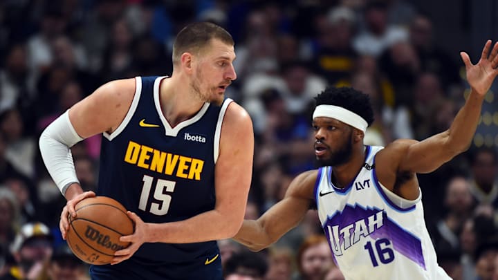 Mar 27, 2026; Denver, Colorado, USA; Denver Nuggets center Nikola Jokic (15) looks to pass the ball as he is defended by Utah Jazz guard Elijah Harkless (16) during the first half at Ball Arena. Mar 27, 2026; Denver, Colorado, USA; Denver Nuggets center Nikola Jokic (15) looks to pass the ball as he is defended by Utah Jazz guard Elijah Harkless (16) during the first half at Ball Arena.