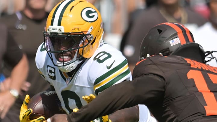 Green Bay Packers running back Josh Jacobs runs with the ball as Browns linebacker Jerome Baker (17) tries to make the tackle.