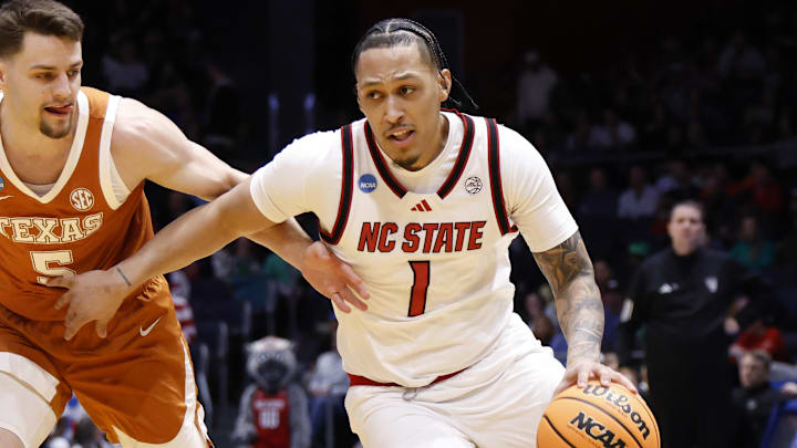 Mar 17, 2026; Dayton, OH, USA; NC State Wolfpack forward Darrion Williams (1) dribbles defended by Texas Longhorns forward Camden Heide (5) in the first half during a first four game of the men's 2026 NCAA Tournament at University of Dayton Arena. Mandatory Credit: Rick Osentoski-Imagn Images