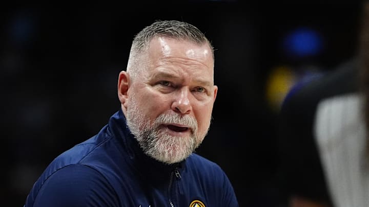 Apr 6, 2025; Denver, Colorado, USA; Denver Nuggets head coach Michael Malone reacts towards referee Danielle Scott (87) in the second half against the Indiana Pacers at Ball Arena. Mandatory Credit: Ron Chenoy-Imagn Images