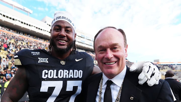 Oct 11, 2025; Boulder, Colorado, USA; Colorado Buffaloes offensive lineman Jordan Seaton (77) and athletic director Rick George following the win against the Iowa State Cyclones  at Folsom Field. 