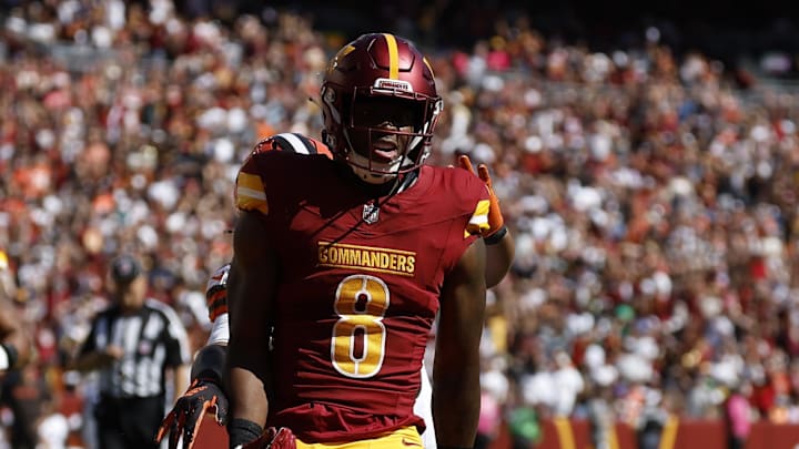 Oct 6, 2024; Landover, Maryland, USA; Washington Commanders running back Brian Robinson Jr. (8) celebrates after scoring a touchdown against the Cleveland Browns during the first quarter at NorthWest Stadium. Mandatory Credit: Geoff Burke-Imagn Images