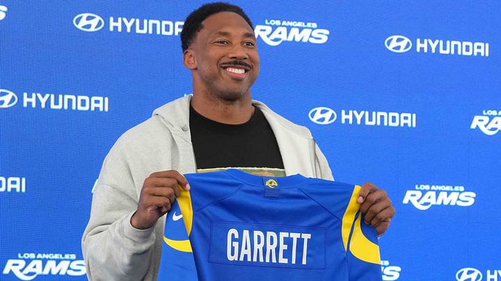 Jun 2, 2026; Woodland Hills, CA, USA; Los Angeles Rams defensive end Myles Garrett (95) poses with jersey at press conference at Rams Practice Facility. Mandatory Credit: Kirby Lee-Imagn Images