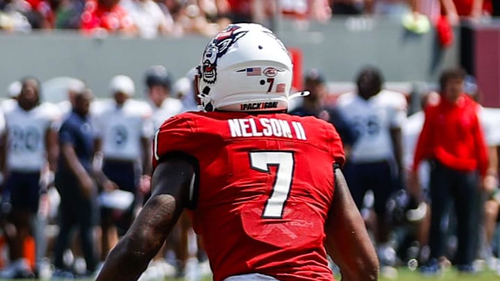 Sep 6, 2025; Raleigh, North Carolina, USA; Virginia Cavaliers tight end Sage Ennis (0) runs with the football by North Carolina State Wolfpack safety Brody Barnhardt (29), cornerback Brian Nelson II (7) and cornerback Jackson Vick (22) during the first half of the game at Carter-Finley Stadium. Mandatory Credit: Jaylynn Nash-Imagn Images