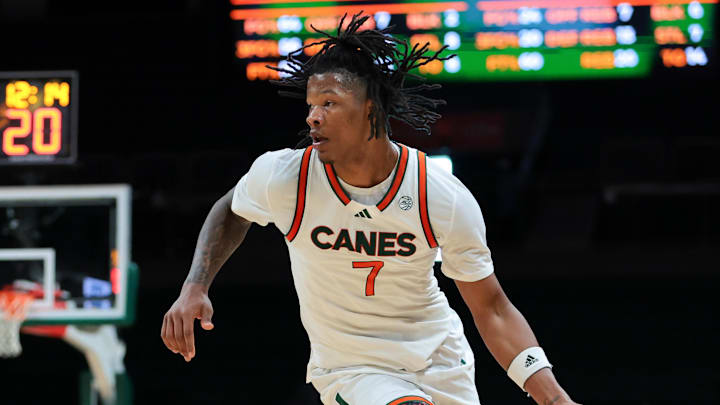 Nov 23, 2025; Coral Gables, Florida, USA; Miami Hurricanes forward Shelton Henderson (7) drives to the basket against Delaware State Hornets guard John Clemmons (5) during the second half at Watsco Center. Mandatory Credit: Sam Navarro-Imagn Images