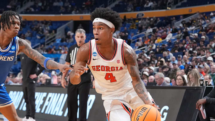 Mar 19, 2026; Buffalo, NY, USA; Georgia Bulldogs guard Marcus Millender (4) drives to the basket against Saint Louis Billikens guard Quentin Jones (1) during the second half of a first round game of the men's 2026 NCAA Tournament at Keybank Center. Mandatory Credit: Gregory Fisher-Imagn Images