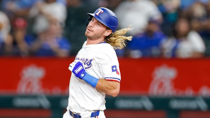 Sep 21, 2024; Arlington, Texas, USA; Texas Rangers outfielder Travis Jankowski (16) hits a double during the eighth inning against the Seattle Mariners at Globe Life Field.