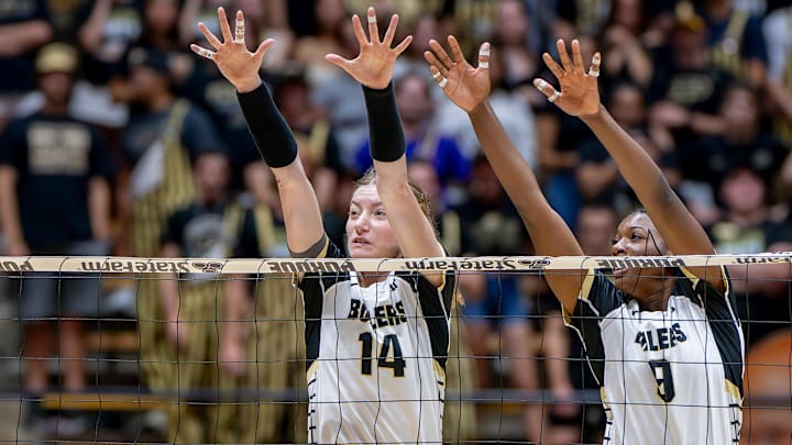 Purdue Redshirt Sophomore Grace Heaney (14) and Purdue Junior Dior Charles (9) watch as the ball Purdue Redshirt Sophomore Grace Heaney (14) and Purdue Junior Dior Charles (9) watch as the ball