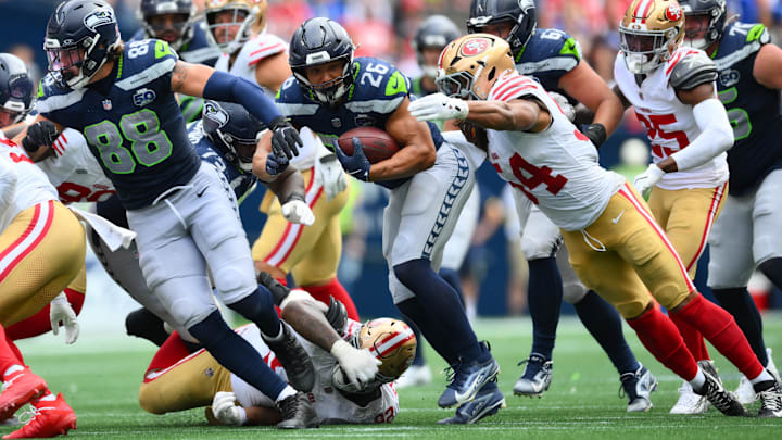 Sep 7, 2025; Seattle, Washington, USA; Seattle Seahawks running back Zach Charbonnet (26) runs the ball  during the second half against San Francisco 49ers at Lumen Field