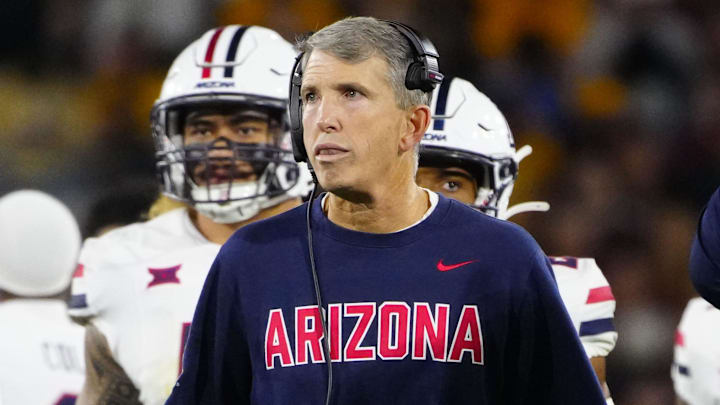 Arizona head coach Brent Brennan walks to the end zone with his team during a game against Arizona State at Mountain America Stadium in Tempe on Nov. 28, 2025.