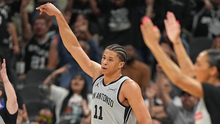 Apr 8, 2026; San Antonio, Texas, USA; San Antonio Spurs forward Carter Bryant (11) and fans react after scoring a three point basket during the second half against the Portland Trail Blazers at Frost Bank Center. Mandatory Credit: Scott Wachter-Imagn Images