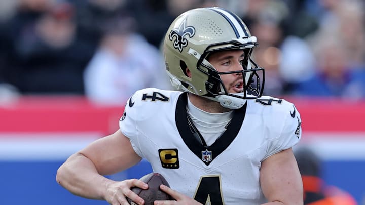 Dec 8, 2024; East Rutherford, New Jersey, USA; New Orleans Saints quarterback Derek Carr (4) drops back to pass against the New York Giants during the first quarter at MetLife Stadium. Mandatory Credit: Brad Penner-Imagn Images