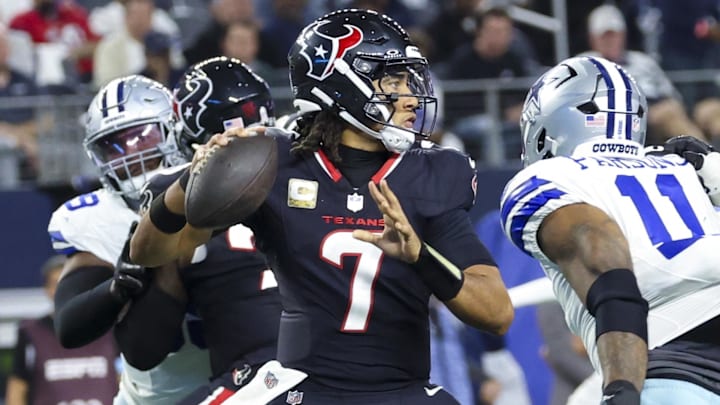 Nov 18, 2024; Arlington, Texas, USA; Houston Texans quarterback C.J. Stroud (7) throws as Dallas Cowboys linebacker Micah Parsons (11) rushes during the first half at AT&T Stadium. Mandatory Credit: Kevin Jairaj-Imagn Images