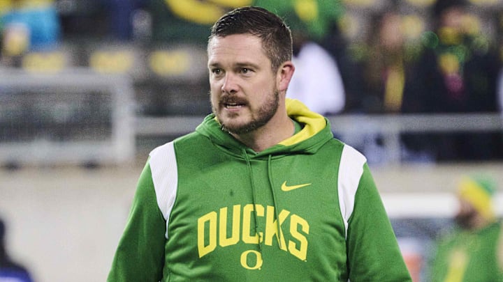 Nov 19, 2022; Eugene, Oregon, USA; Oregon Ducks head coach Dan Lanning watches players warm up before a game against the Utah Utes at Autzen Stadium. Mandatory Credit: Troy Wayrynen-Imagn Images