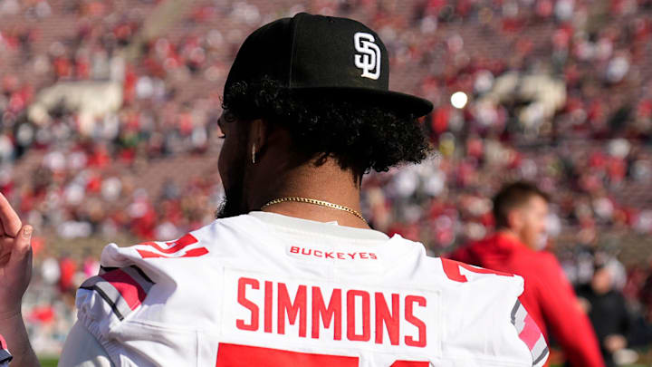 Injured Ohio State Buckeyes offensive linemen Seth McLaughlin (56) and Josh Simmons (71) watch warm ups prior to the College Football Playoff quarterfinal against the Oregon Ducks at the Rose Bowl in Pasadena, Calif. on Jan. 1, 2025. Ohio State won 41-21.