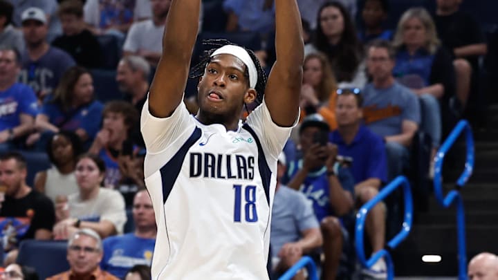 Apr 14, 2024; Oklahoma City, Oklahoma, USA; Dallas Mavericks forward Olivier-Maxence Prosper (18) shoots as Oklahoma City Thunder forward Jaylin Williams (6) defends during the second quarter at Paycom Center. Mandatory Credit: Alonzo Adams-Imagn Images