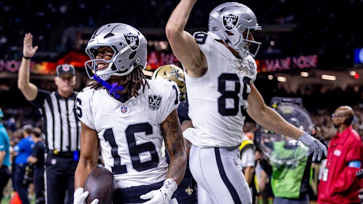 Dec 29, 2024; New Orleans, Louisiana, USA;  Las Vegas Raiders wide receiver Jakobi Meyers (16) runs in from a touchdown against New Orleans Saints cornerback Alontae Taylor (1) during the first half at Caesars Superdome. Mandatory Credit: Stephen Lew-Imagn Images