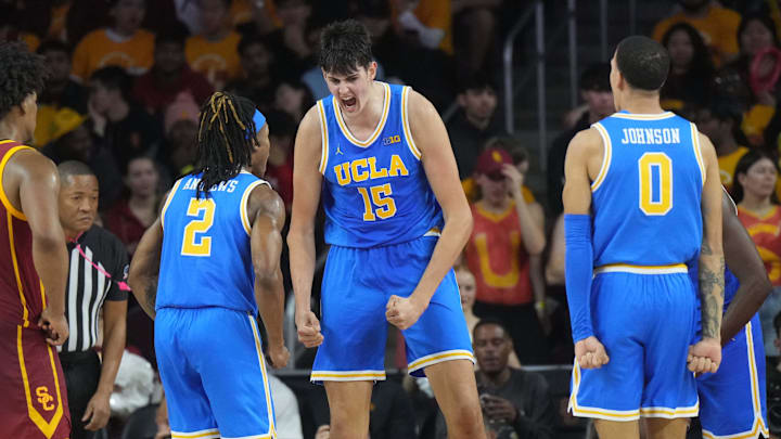 Jan 27, 2025; Los Angeles, California, USA; UCLA Bruins center Aday Mara (15) celebrates with guard Dylan Andrews (2) and guard Kobe Johnson (0) as Southern California Trojans guard Wesley Yates III (6) watches in the second half at the Galen Center. Mandatory Credit: Kirby Lee-Imagn Images Jan 27, 2025; Los Angeles, California, USA; UCLA Bruins center Aday Mara (15) celebrates with guard Dylan Andrews (2) and guard Kobe Johnson (0) as Southern California Trojans guard Wesley Yates III (6) watches in the second half at the Galen Center. Mandatory Credit: Kirby Lee-Imagn Images