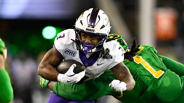 Dec 20, 2025; Eugene, OR, USA;  James Madison Dukes running back Wayne Knight (3) rushes as Oregon Ducks defensive back Aaron Flowers (21) defends during the second quarter at Autzen Stadium. Mandatory Credit: Troy Wayrynen-Imagn Images