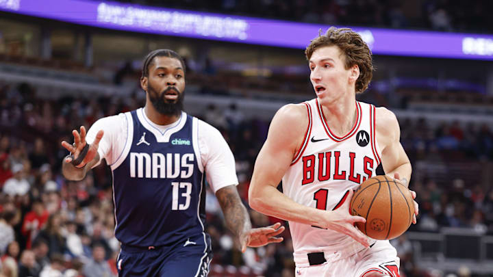 Jan 10, 2026; Chicago, Illinois, USA; Chicago Bulls forward Matas Buzelis (14) drives to the basket against Dallas Mavericks forward Naji Marshall (13) during the first half at United Center. Mandatory Credit: Kamil Krzaczynski-Imagn Images