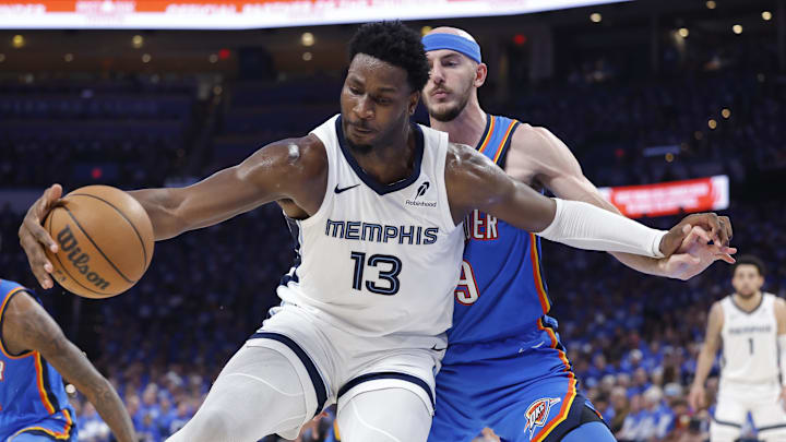 Apr 22, 2025; Oklahoma City, Oklahoma, USA; Memphis Grizzlies forward Jaren Jackson Jr. (13) moves the ball against Oklahoma City Thunder guard Alex Caruso (9) in the third quarter during game two of first round for the 2024 NBA Playoffs at Paycom Center. Mandatory Credit: Alonzo Adams-Imagn Images