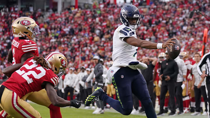 Nov 17, 2024; Santa Clara, California, USA; Seattle Seahawks quarterback Geno Smith (7) scores a rushing touchdown past San Francisco 49ers cornerback Isaac Yiadom (22) to win the game in the fourth quarter at Levi's Stadium.