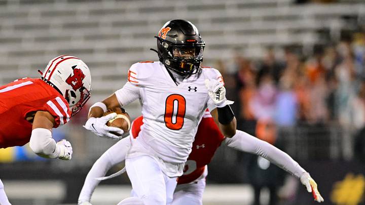 Nick Abrams of McDonogh (0) runs for extra yardage in the 2023 MIAA A Conference championship game against Archbishop Spalding.