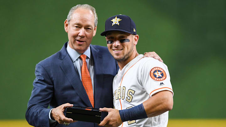 Apr 3, 2018; Houston, TX, USA; Houston Astros third baseman Alex Bregman (2) poses with owner Jim Crane as he receives his ring during the World Series ring ceremony at Minute Maid Park. 