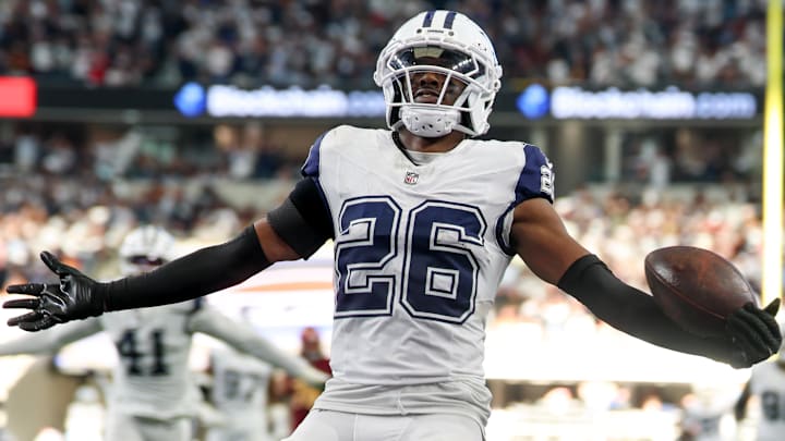 Oct 19, 2025; Arlington, Texas, USA; Dallas Cowboys cornerback Daron Bland (26) carries the ball after an interception for a touchdown against the Washington Commanders during the third quarter of the game at AT&T Stadium.