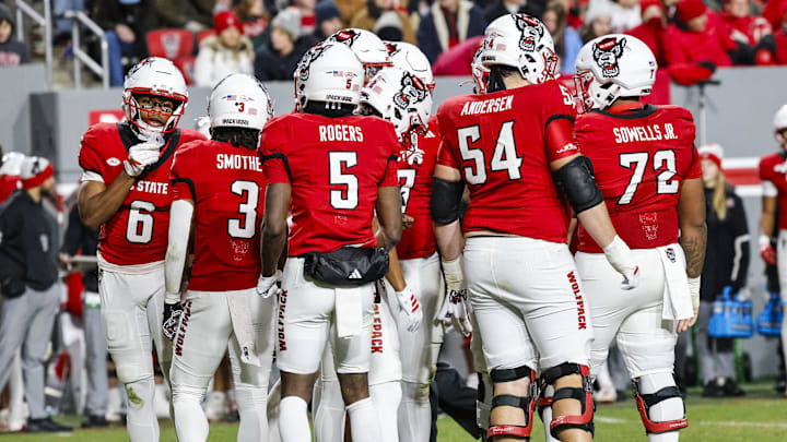 Nov 29, 2025; Raleigh, North Carolina, USA;  NC State Wolfpack huddles during the first half of the game against North Carolina Tar Heels at Carter-Finley Stadium.  Mandatory Credit: Jaylynn Nash-Imagn Images
